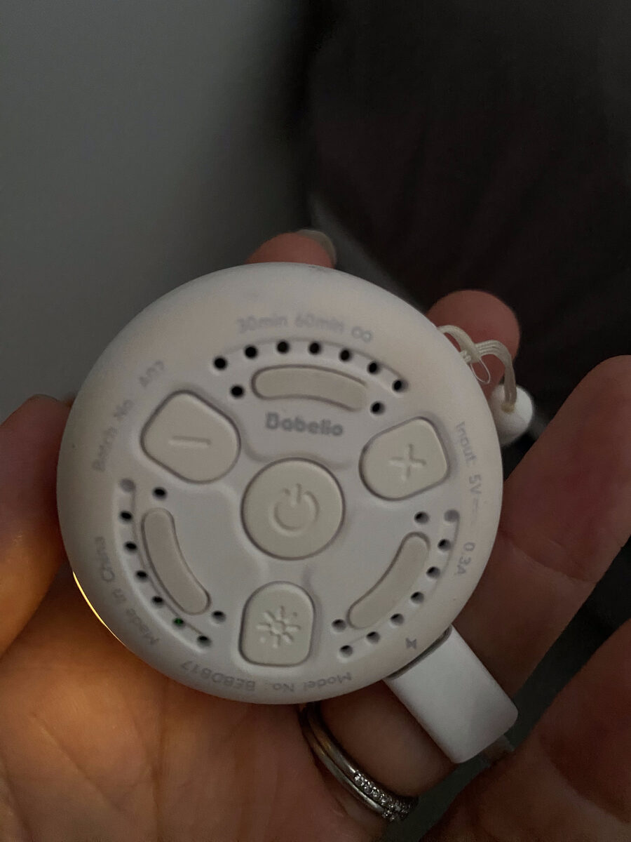 Back of the Babelio white noise machine showing the volume, timer, and night light buttons