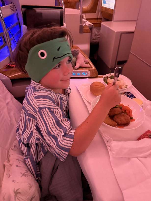 kids headphones for travel: my son wearing his CozyPhones on the plane