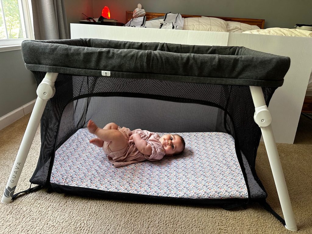 Guava Lotus travel crib, set up and ready - second mattress, second kid.